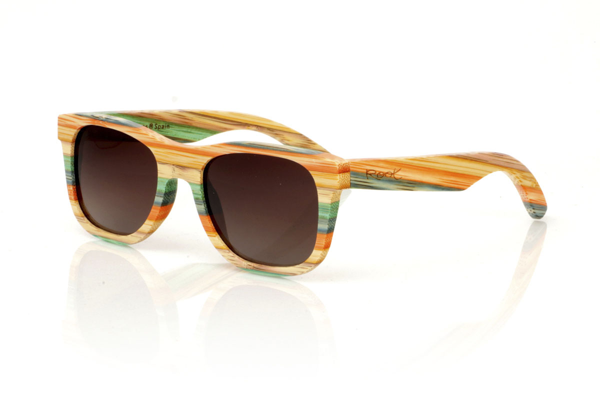 Wood eyewear of Bamboo KASHBAH. KASHBAH sunglasses, with a classic design and a slightly smaller size than the standard, make the difference in our bamboo collection. These glasses are made of vertically laminated bamboo wood, creating a pattern of soft colors that capture the light and the gaze of whoever sees them. The colorful result is not only visually attractive, but also adds a touch of originality and freshness to your style. With measurements of 143x46 and a caliber of 52, the KASHBAH are perfect for those looking for comfortable, light glasses with a unique touch that will not go unnoticed. for Wholesale & Retail | Root Sunglasses® 